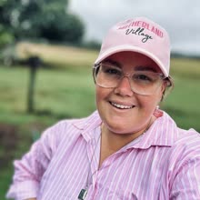 A Motherland Village mum in her pink cap