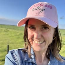 A Motherland Village mum in her pink cap