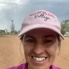 A Motherland Village mum in her pink cap