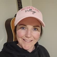 A Motherland Village mum in her pink cap