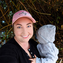 A Motherland Village mum in her pink cap